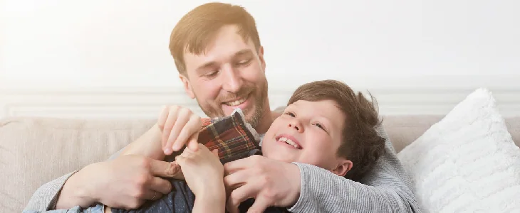Smiling dad holding son in his hands