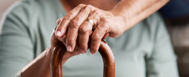 Elder women holding top of a cane
